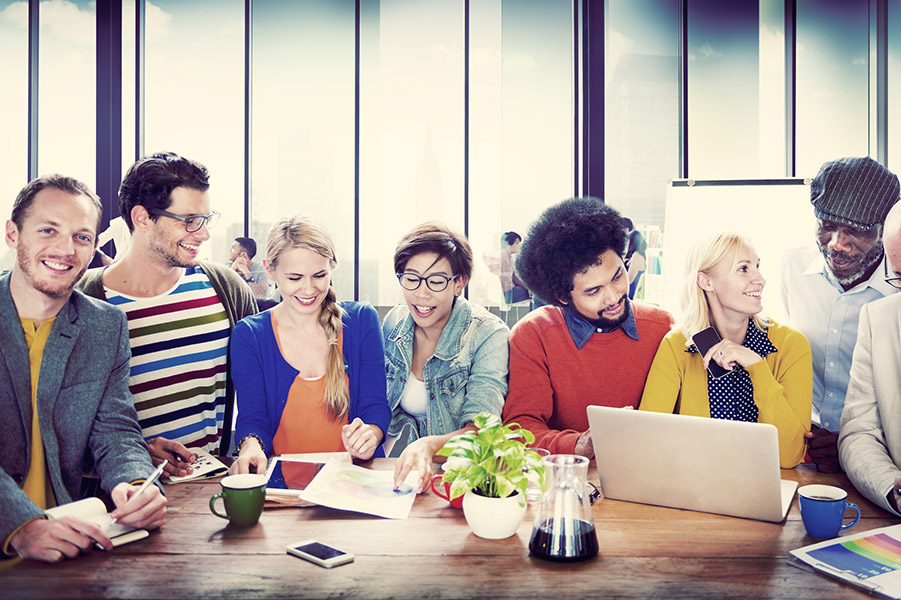 Group of young people from different backgrounds together at the laptop