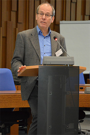 Professor Bernd Fitzenberger standing at a desk talking to the audience.
