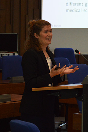 Associate Professor Nadine Ketel standing in conference room talking to the audience.