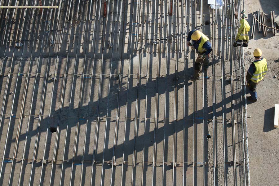 Construction worker at a building site, top view.