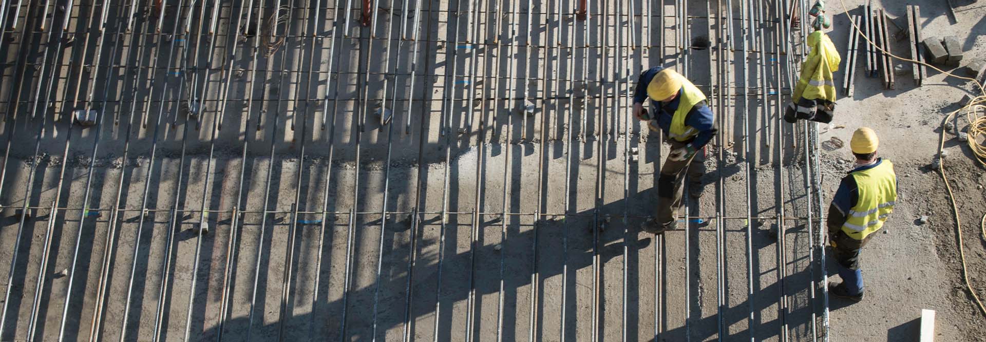 Construction worker at a building site, top view.