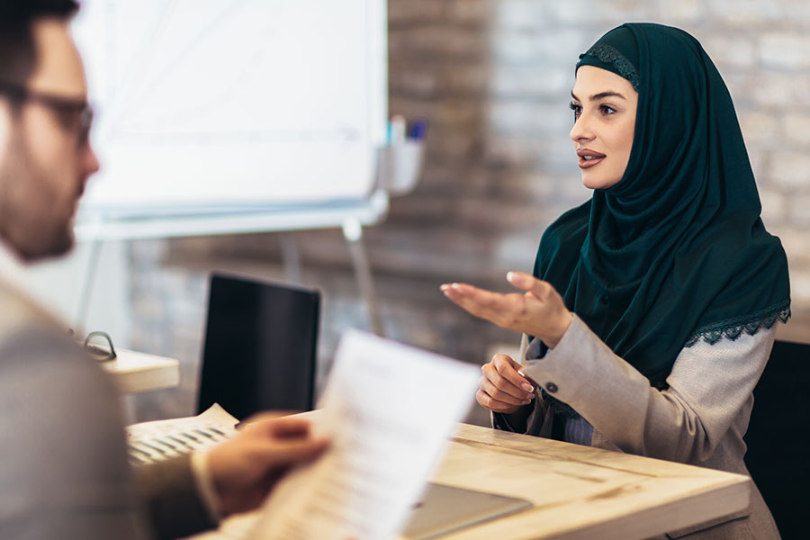 Pretty young Muslim woman with headscarf at job interview